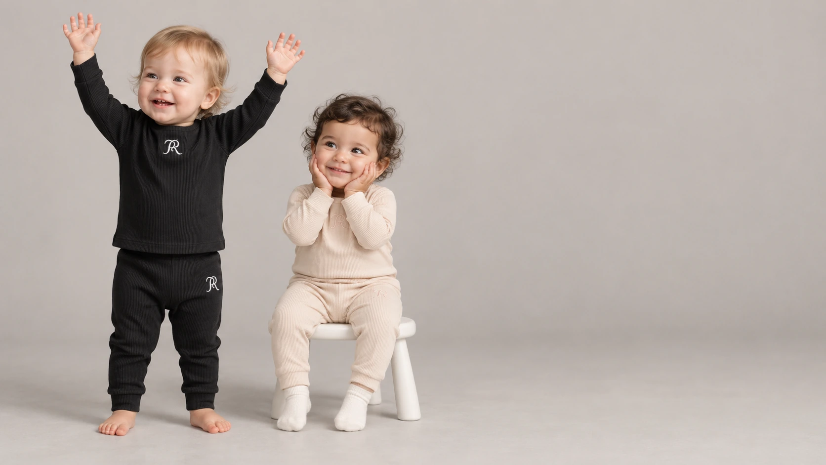 Two toddlers wearing Midnight and Cream ribbed RiceRice Baby sets